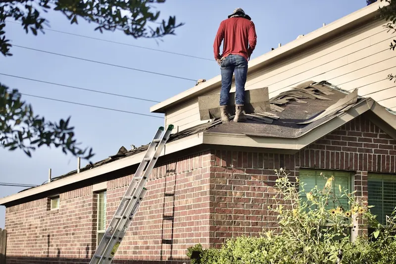 Professional roofer working on a residential roof in Lincroft